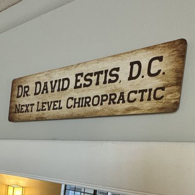 Sign reading: Dr. David Estis D.C. Next Level Chiropractic