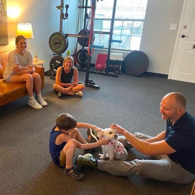 Family and dog hanging out at the Next Level Chiropractic office