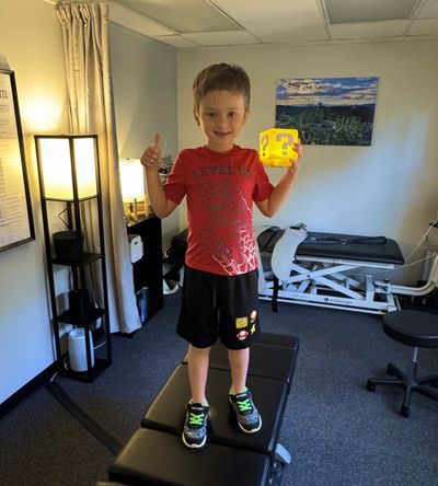 Photo of happy child patient who just received an adjustment from chiropractor Dr. David Estis