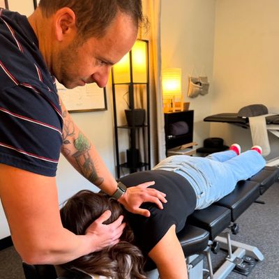 Chiropractor Dr. David Estis performing a chiropractic adjustment on a patient