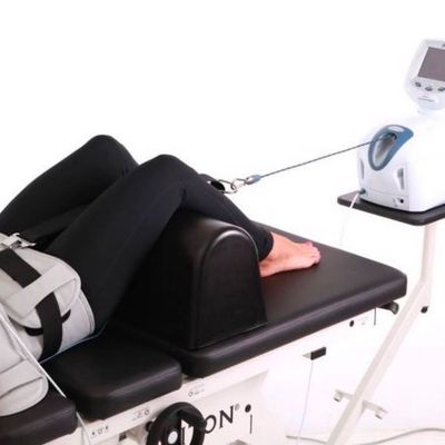 Woman receiving spinal decompression from a machine