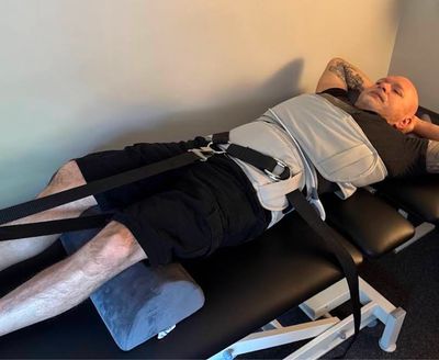 Man in the Next Level Chiropractic office in Centennial, CO receiving spinal decompression treatment